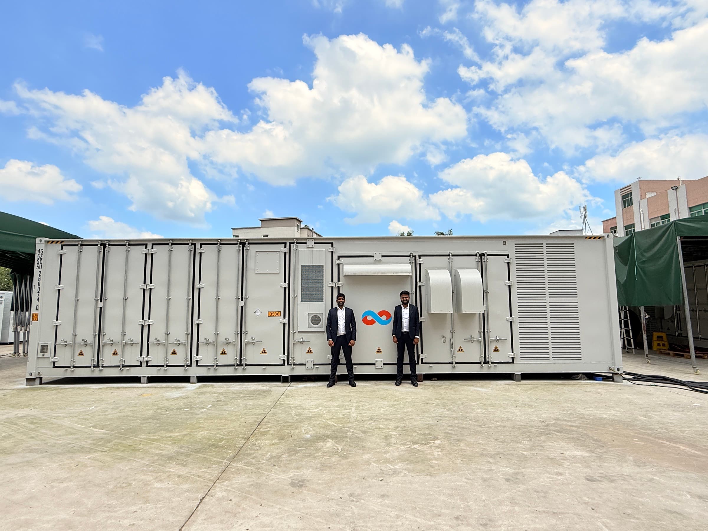Infinity Power Group containerised battery energy storage system in a commissioning yard under a blue sky